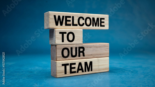 Wooden blocks stacked to spell out welcome to our team against a vibrant blue background symbolizing new beginnings and team integration