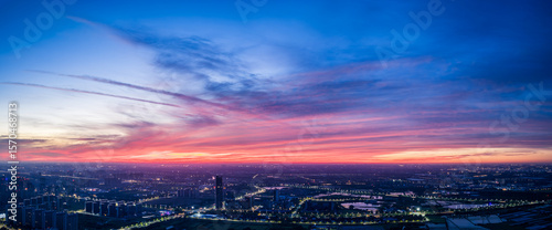Panoramic view of city skyline with spectacular colorful sky clouds at dusk