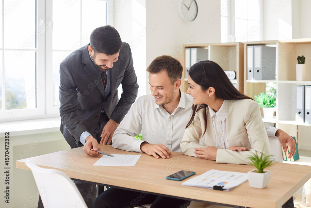 Obraz premium Group of business people or company employees sitting at the desk looking through financial documents, reaching agreement and going signing a contract. Coworkers having a meeting in office.