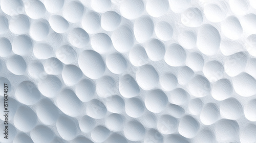 Textured white surface with dimpled circles ideal for background designs, product photography, or abstract artistic applications in minimalist projects.