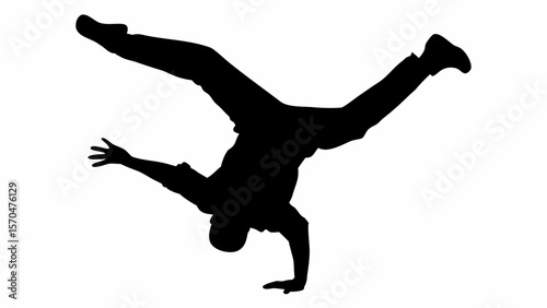 Silhouette of a man doing a handstand with legs spread and one arm extended out for balance pose