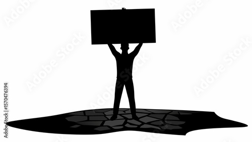Silhouette of person holding a rectangular sign aloft while standing on a fractured stone surface area