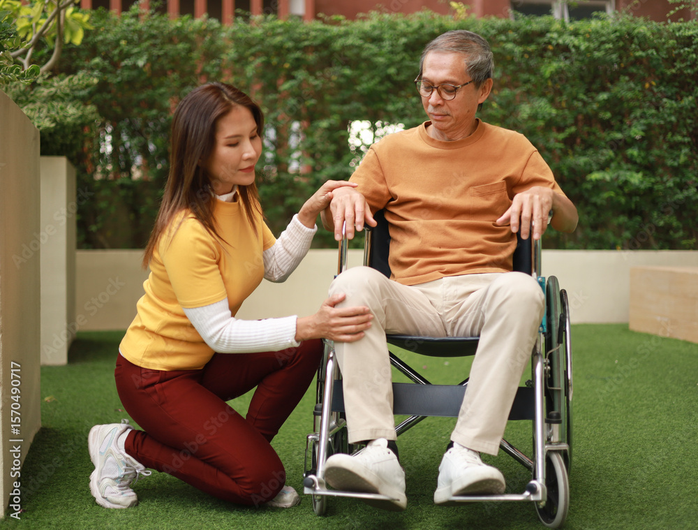 Obraz premium Help support retirement health care. A man is being cared for privately at home by an Asian woman who has Alzheimer's and is being closely monitored.
