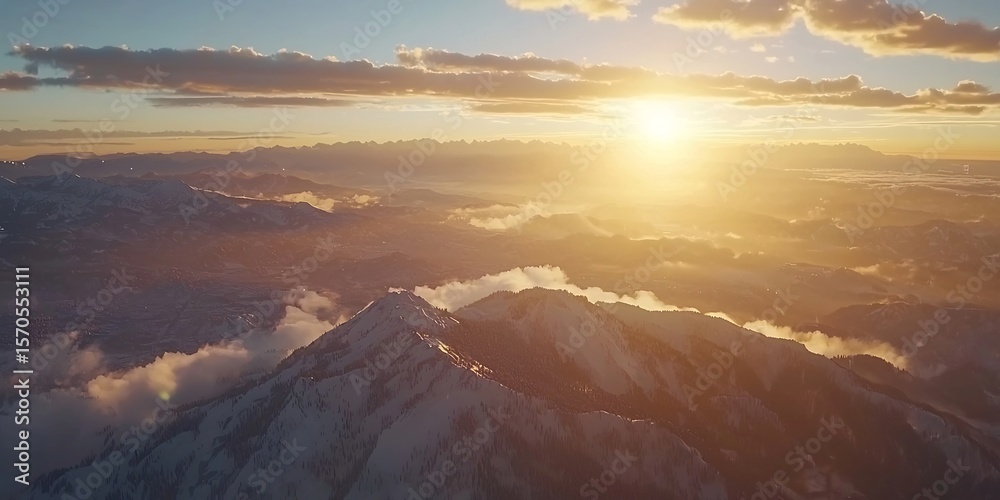 Obraz premium Majestic snow-covered mountain peaks bathed in the warm glow of the rising sun