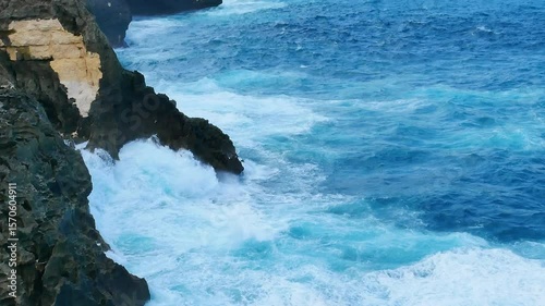 Turquoise ocean sea water white wave splashing deep blue sea. Bird eye view monster wave splash on rock. Tropical sea beach in summer seaside outdoor. Ocean island beautiful dramatic landscape. 