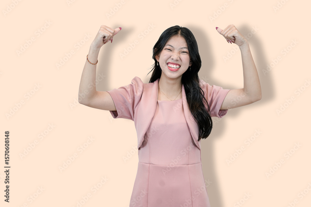 Naklejka premium Young Asian Woman Flexing Biceps, Showing Strength 