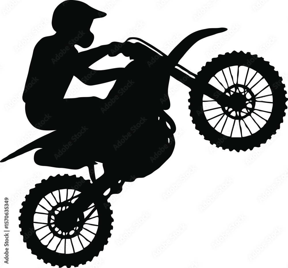 Fototapeta premium Silhouette of Motocross Rider Performing a Wheelie Extreme Sports Action