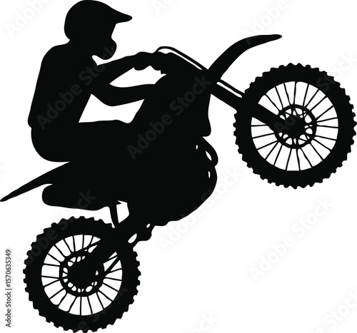 Silhouette of Motocross Rider Performing a Wheelie Extreme Sports Action