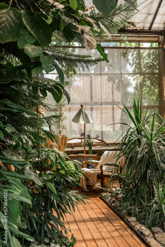 Rustic greenhouse reading nook with tropical foliage for concepts of comfort, serenity and eco-friendly interior