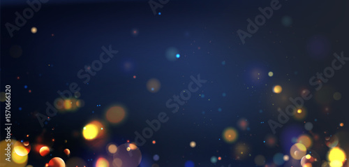 Festive bokeh lights on dark blue background - gold yellow orbs floating with bright sparkles. Blurred glowing circles and shimmering dots for celebration wallpaper or holiday party backdrop design.