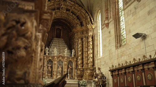 ornate golden baroque altar with statues and stairway in a richly decorated church interior