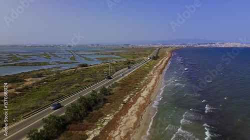 Wallpaper Mural A stunning aerial view of a coastal landscape featuring wetlands, a road, and the sea. Torontodigital.ca