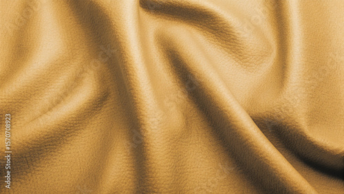 Golden, soft silk satin fabric with a smooth, shiny texture creates a luxurious and elegant golden textile background pattern