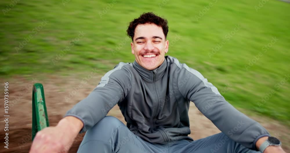 Face, laughing and roundabout with man at playground for excitement, freedom or fun outdoor. Activity, funny and spinning with happy person on merry go round in park for holiday, vacation or weekend