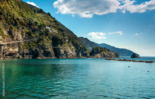 The coast with crystal clear water and green terraces on the slopes of Cinque...