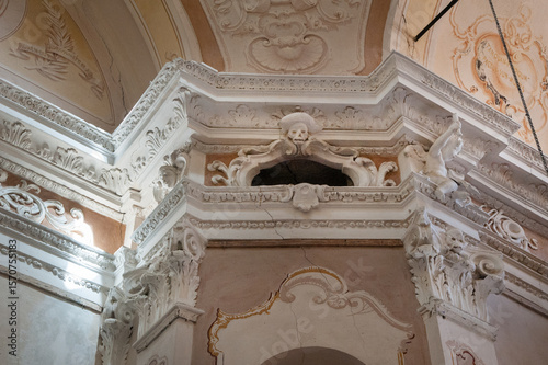 Baroque interior of a church in Monterosso al Mare with rich molding and symb...