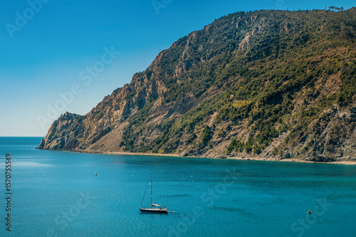 Monterosso al Mare, a quiet bay with crystal clear water and a yacht, rocky s...