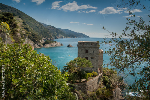 Medieval fortress in the bay of Monterosso al Mare coast above the turquoise sea