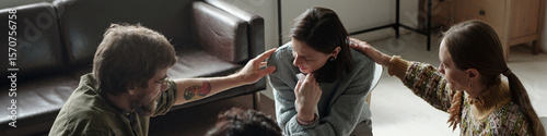 Fotografía Woman sitting in therapy session receiving comfort from man and woman, group sup