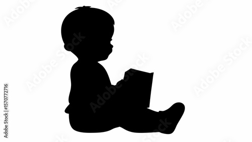 Silhouette of a baby sitting and reading a book with focus on early learning and childhood development