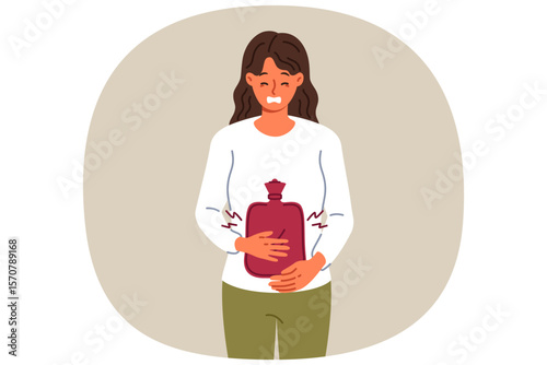 Suffering sick woman uses rubber heating pad to relieve abdominal pain caused by menstrual cycles. Sick girl needs doctors help or medicine to treat problems with digestive system.