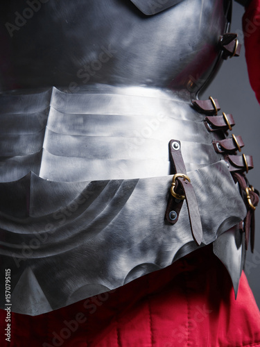 Fotografie Intricate close-up of polished steel medieval armor breastplate with leather straps