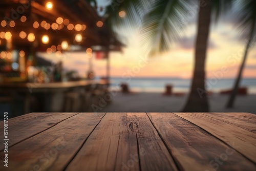 Wooden table top with a blurred background of a beach bar at sunset.