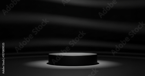 Black cylindrical podium illuminated by spotlight against dark draped background featured in a minimal branding concept for design-focused products