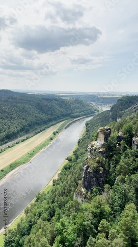 Vertical video, Saxon Switzerland National Park, rocky terrain valley, river canal, ugc landscape from height, stone mountains, view of the river.