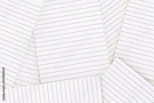 Lined paper strewn over surface