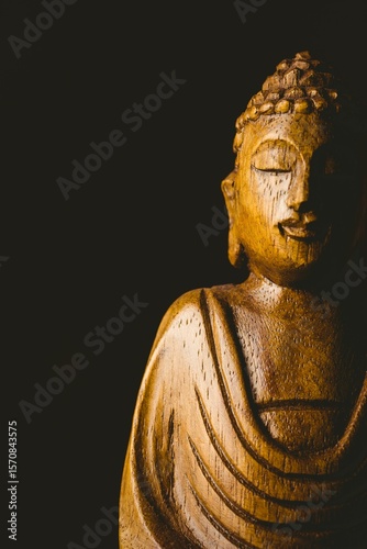 Buddha statue against black background