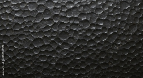Textured Dark Metal Surface Close-up Showing Rough and Hammered Detail