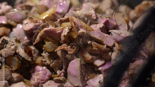 Fry chicken liver with onions in a hot frying pan.
Chicken liver fried in a frying pan. Cooking. Chef. Homemade food.