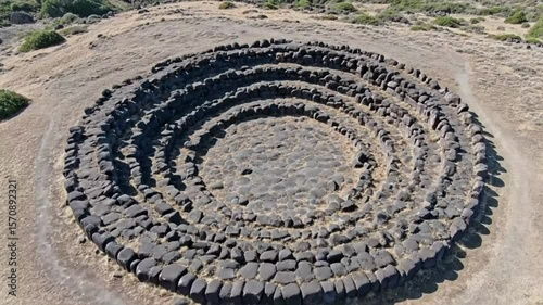 The nuraghe losa archaeological site in sardinia, italy, showcases an ancient stone structure on a grassy hill
