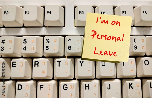 Computer keyboard with note written I'm On Personal Leave - Means business leave - Employee take a leave of absence - Worker take time off for personal or private reasons