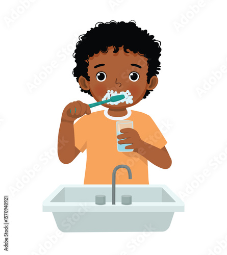 Little African boy brushing teeth with tooth brush for dental care