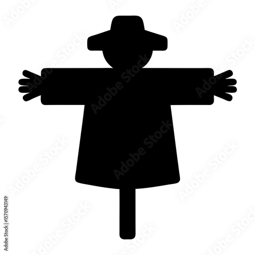 Black silhouette of a scarecrow with hat and outstretched arms standing
