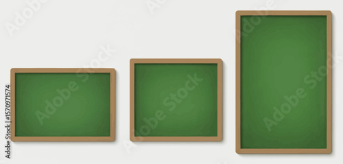 Three green chalkboards of varying sizes arranged horizontally against a white wall