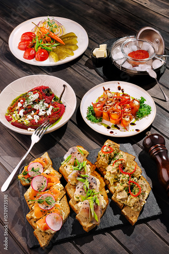Delicious variety of gourmet appetizers served on rustic wooden table