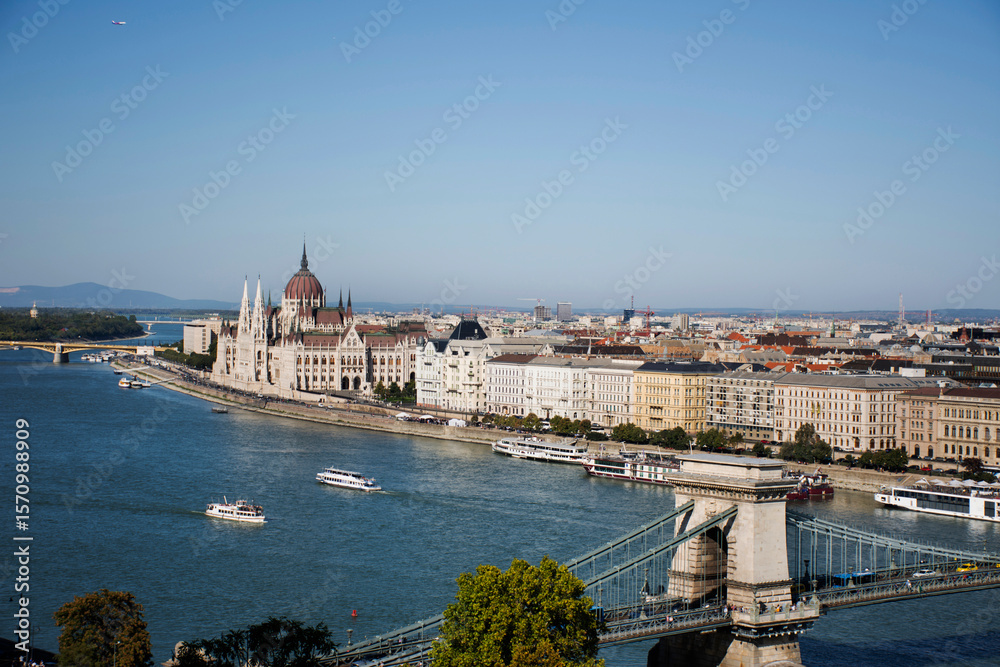 Naklejka premium View landscape and cityscape of Budapest old town city and Hungarian Parliament with tour cruises in Danube Delta river and Budapest Chain Bridge in Budapest, Hungary