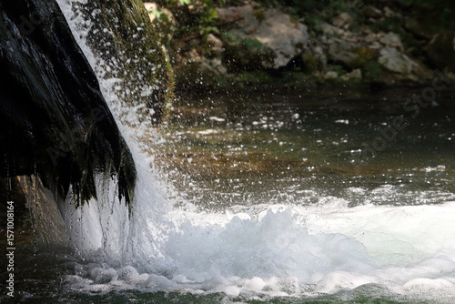 Detail of waterfall on mossy rock in unspoiled nature