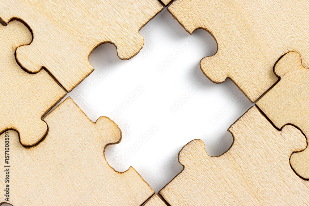 Fototapeta premium wooden jigsaw puzzle with missing pieces exposing empty white background for copy space.