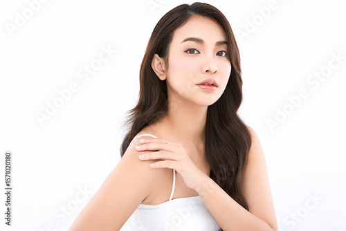 A beautiful young Asian woman with clean, fresh skin against a white background. Skincare, facial treatment, cosmetology, beauty, and spa. An elegant portrait of an Asian woman.
