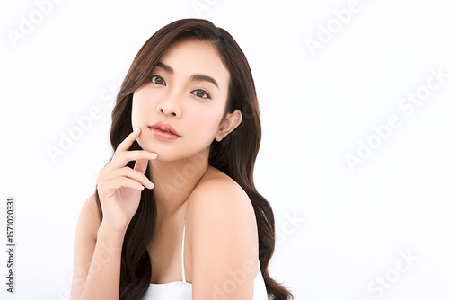 A beautiful young Asian woman with clean, fresh skin against a white background. Skincare, facial treatment, cosmetology, beauty, and spa. An elegant portrait of an Asian woman.
