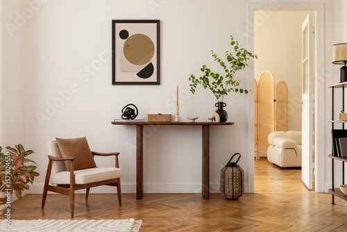 Cozy and stylish interior of living room with mock up poster frame, wooden console, flowers in vase, decorations and personal accessories. Modern home decor. Template.