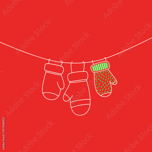 Colorful mittens hanging on a line against a red background
