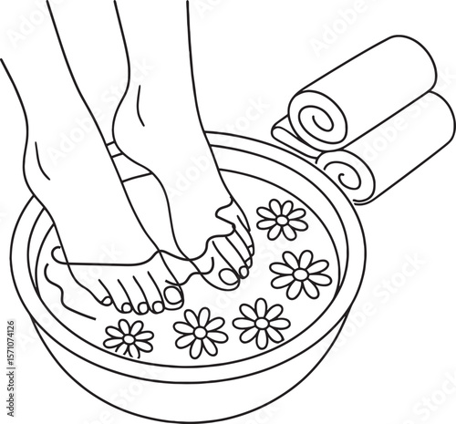 Soaking feet into a flower water in bacin in spa