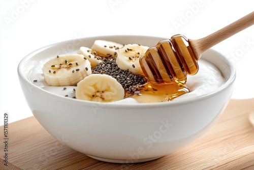 Close-up of a healthy breakfast setup featuring a bowl of yogurt with honey drizzle, chia seeds