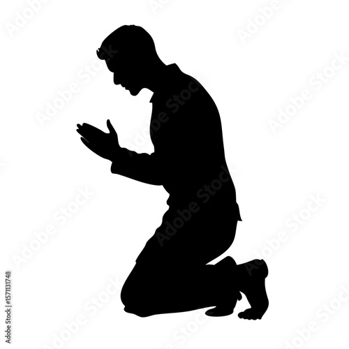 Silhouette of a Person Kneeling in Prayer
