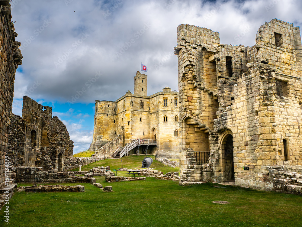 Fototapeta premium Main keep of Warkworth Castle, Northumberland, UK with cloudy sky